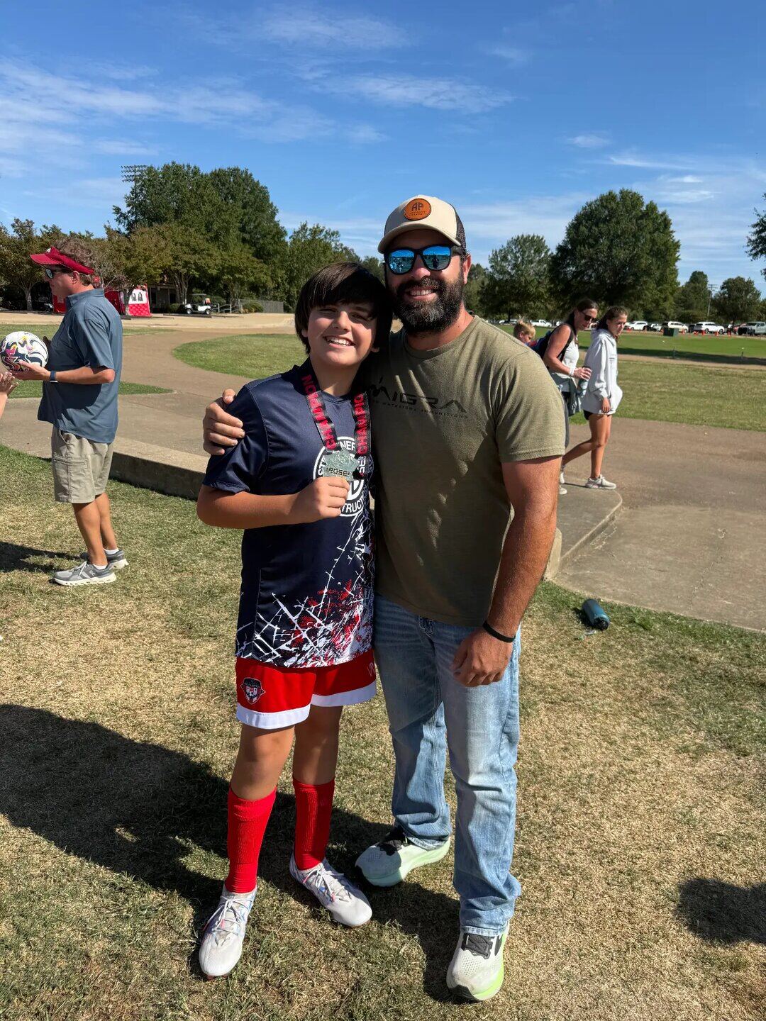 Owner David Heileman with his son Gideon after a soccer championship
